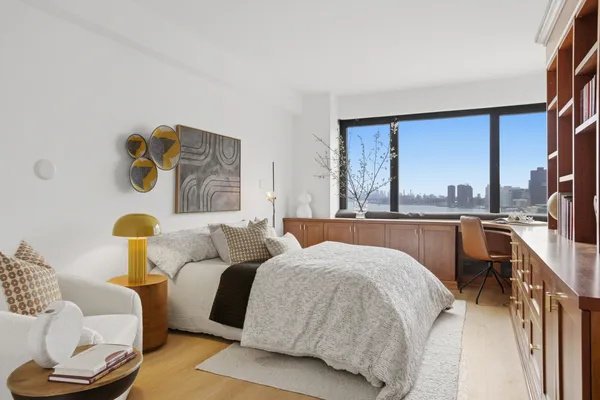 a bedroom with a bed couch and a window
