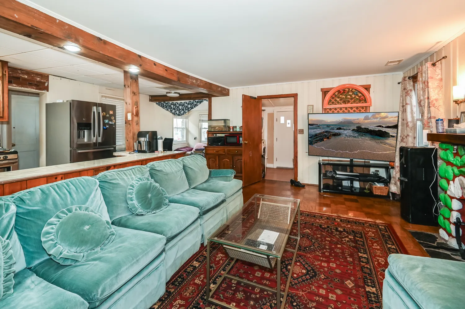 a living room with furniture and a flat screen tv