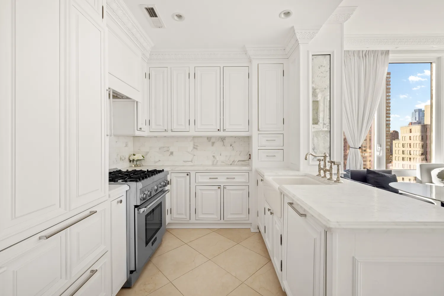 a kitchen with white cabinets and white appliances