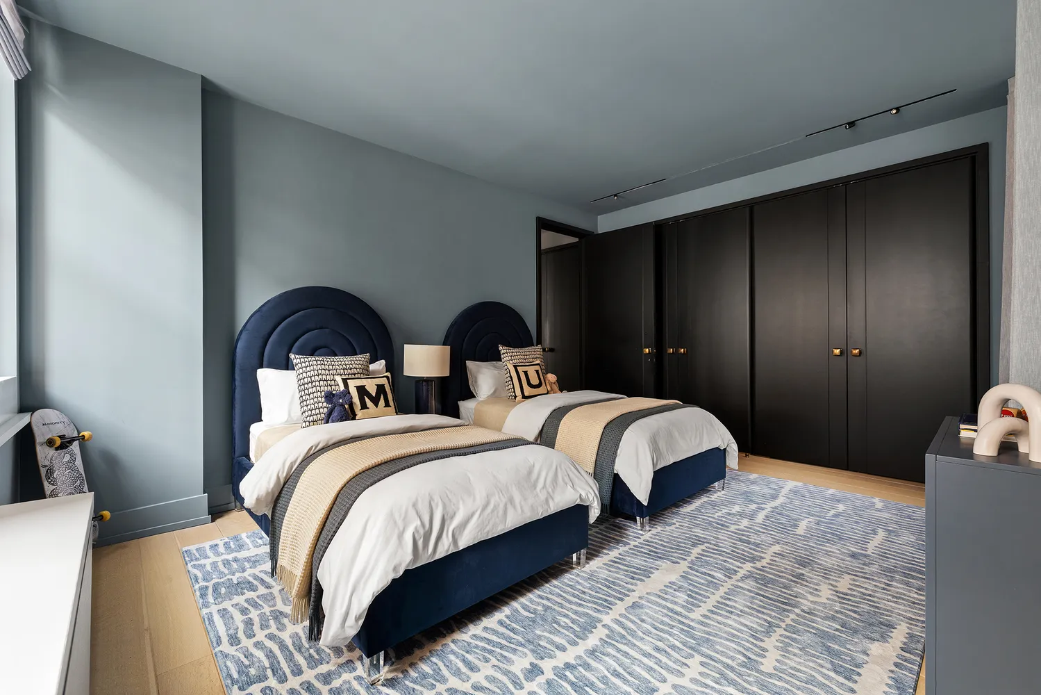 a bedroom with two beds and a couch