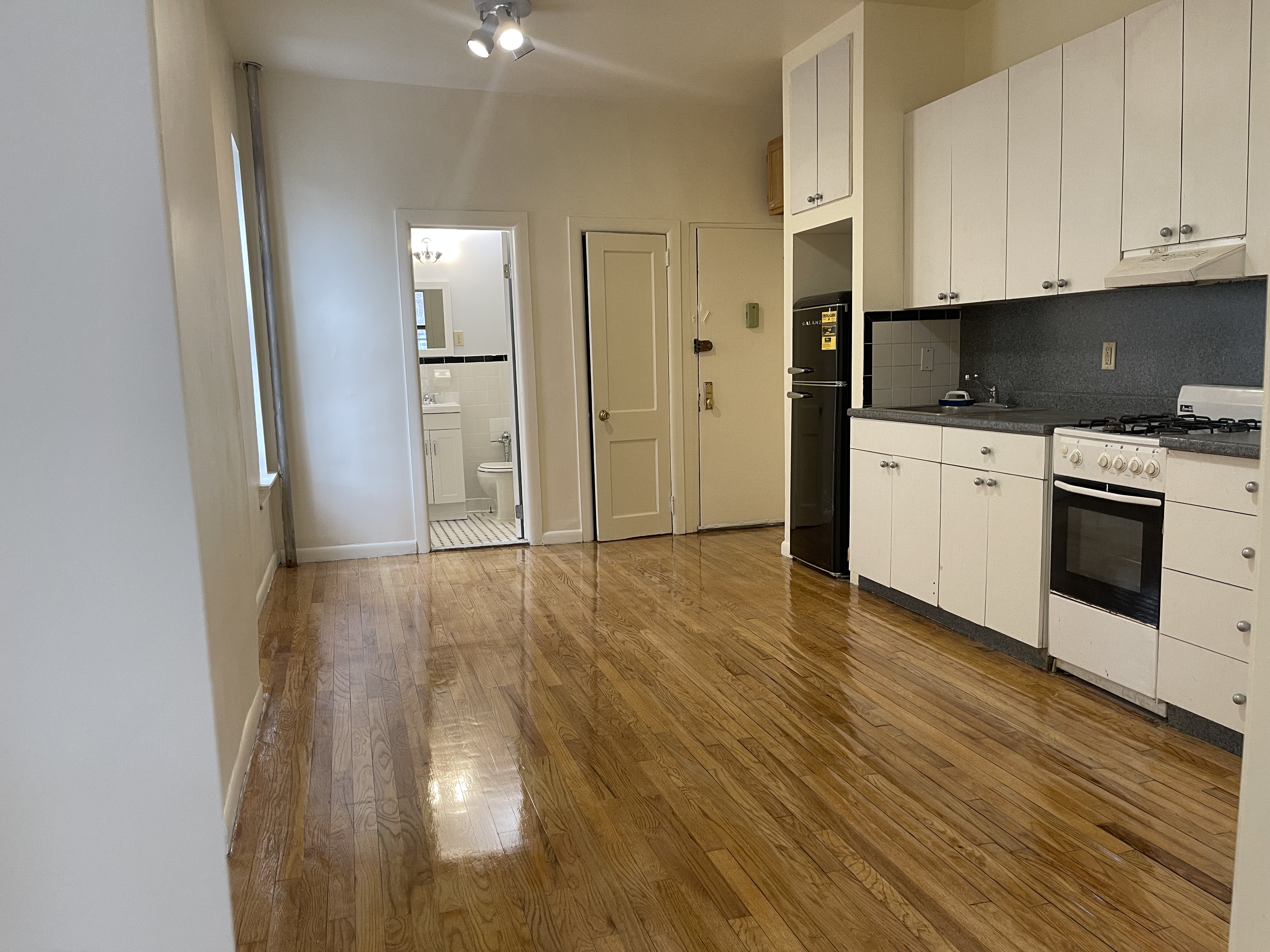 1672 Park Avenue Manhattan, NY 10035 - Photo 6 of 35 a view of a kitchen with a sink and dishwasher a stove top oven with wooden floor