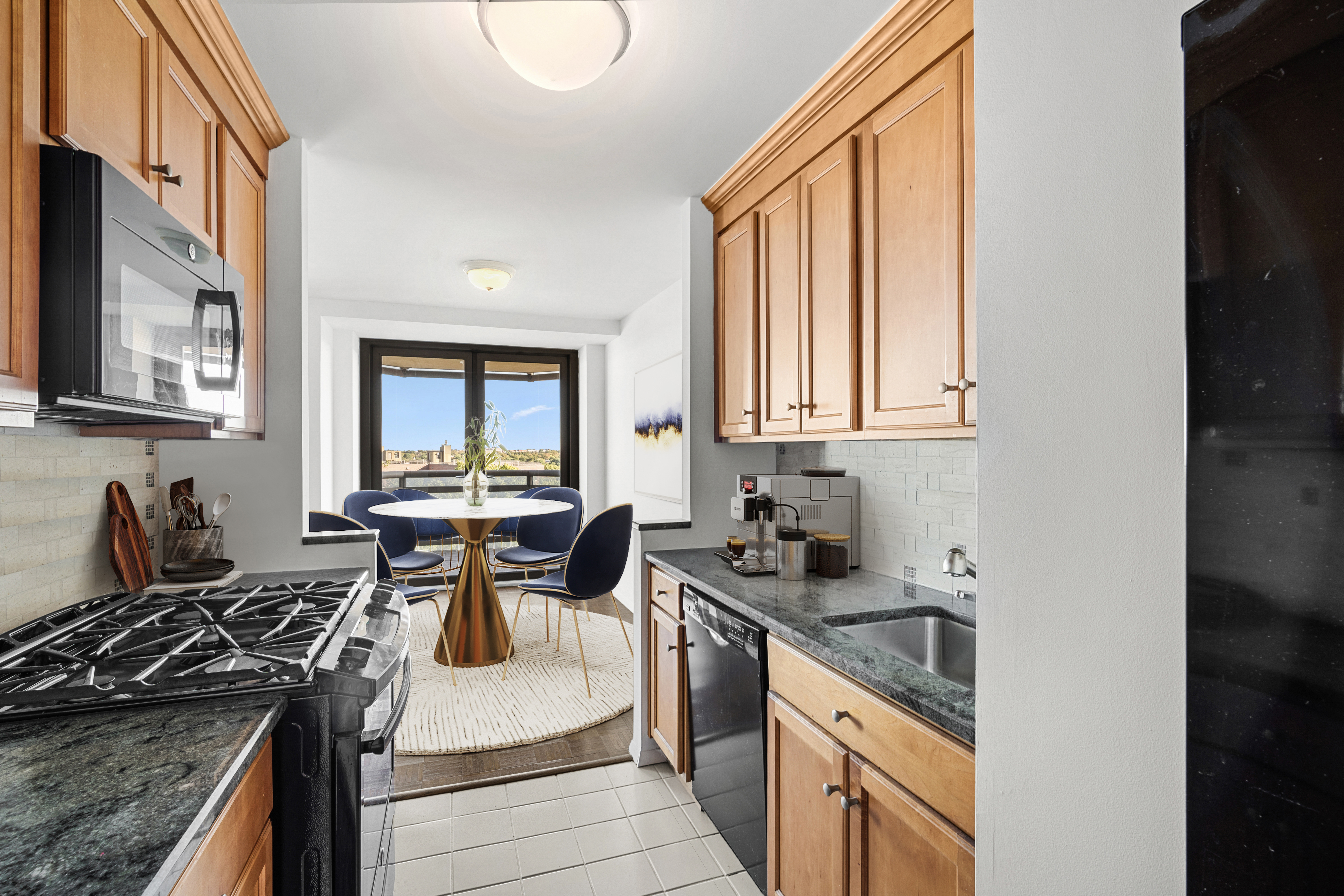 112-01 Queens Boulevard, Unit 8A Queens, NY 11375 - Photo 4 of 19 a kitchen with stainless steel appliances granite countertop a stove a sink and a microwave