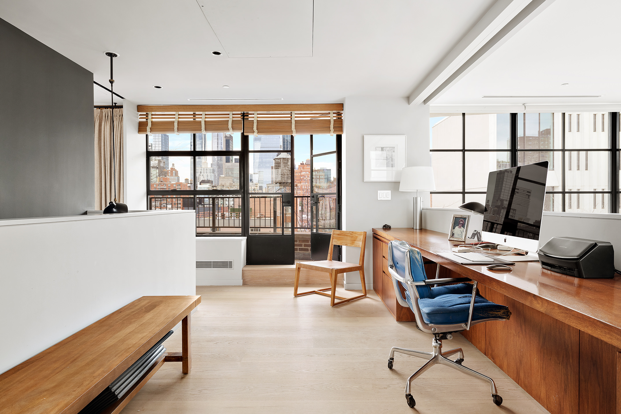 456 West 19th Street, Unit PHG Manhattan, NY 10011 - Photo 9 of 12 a view of a workspace with furniture and a window