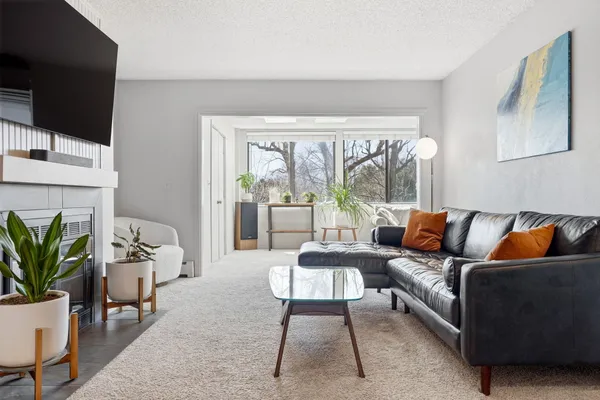 a living room with furniture a flat screen tv and a fireplace