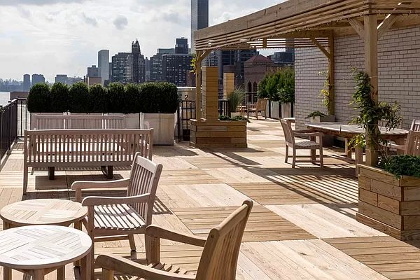 35 Sutton Place, Unit 7E Manhattan, NY 10022 - Photo 17 of 18 a view of a chair and tables on the roof deck