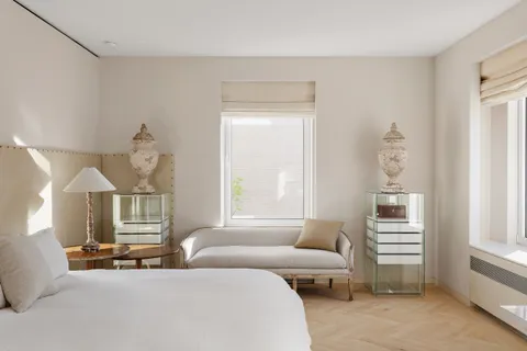 a bedroom with furniture and a window