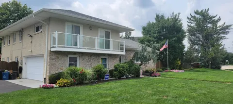 a front view of a house with a garden and plants