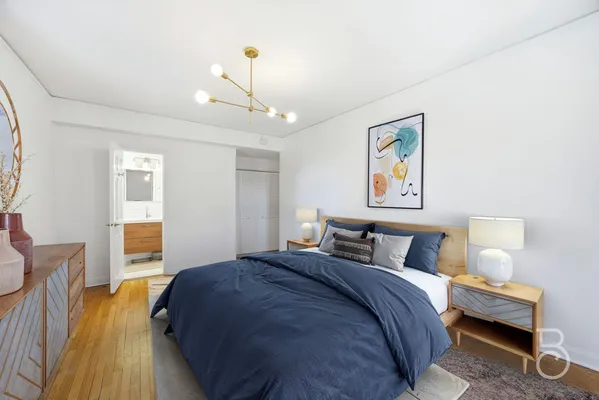 a bedroom with bed and wooden floor
