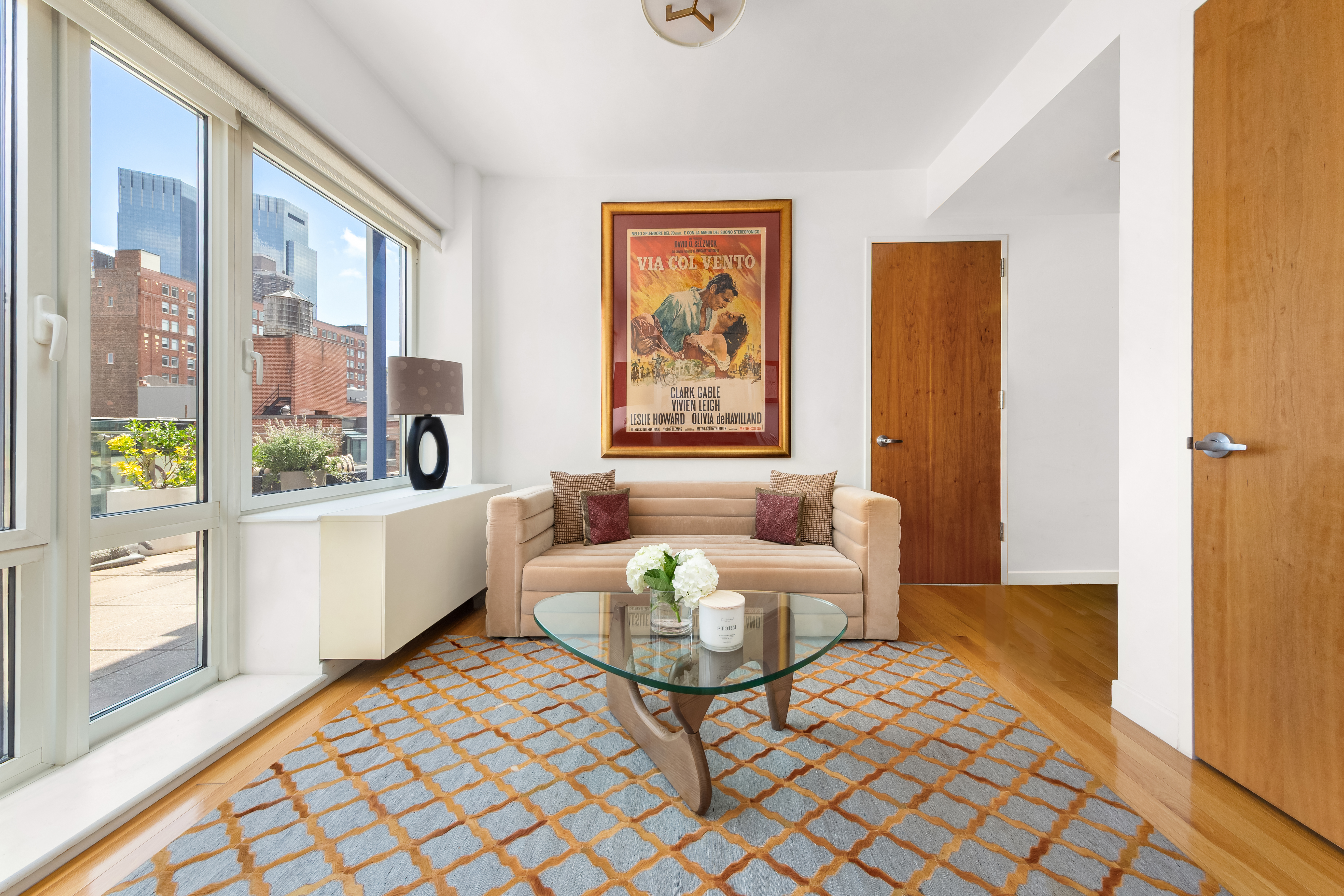 454 West 54th Street, Unit 7B Manhattan, NY 10019 - Photo 5 of 15 a living room with furniture and a large window