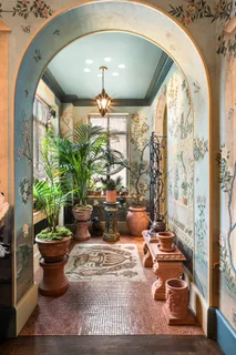 a living room with fireplace furniture and a large window