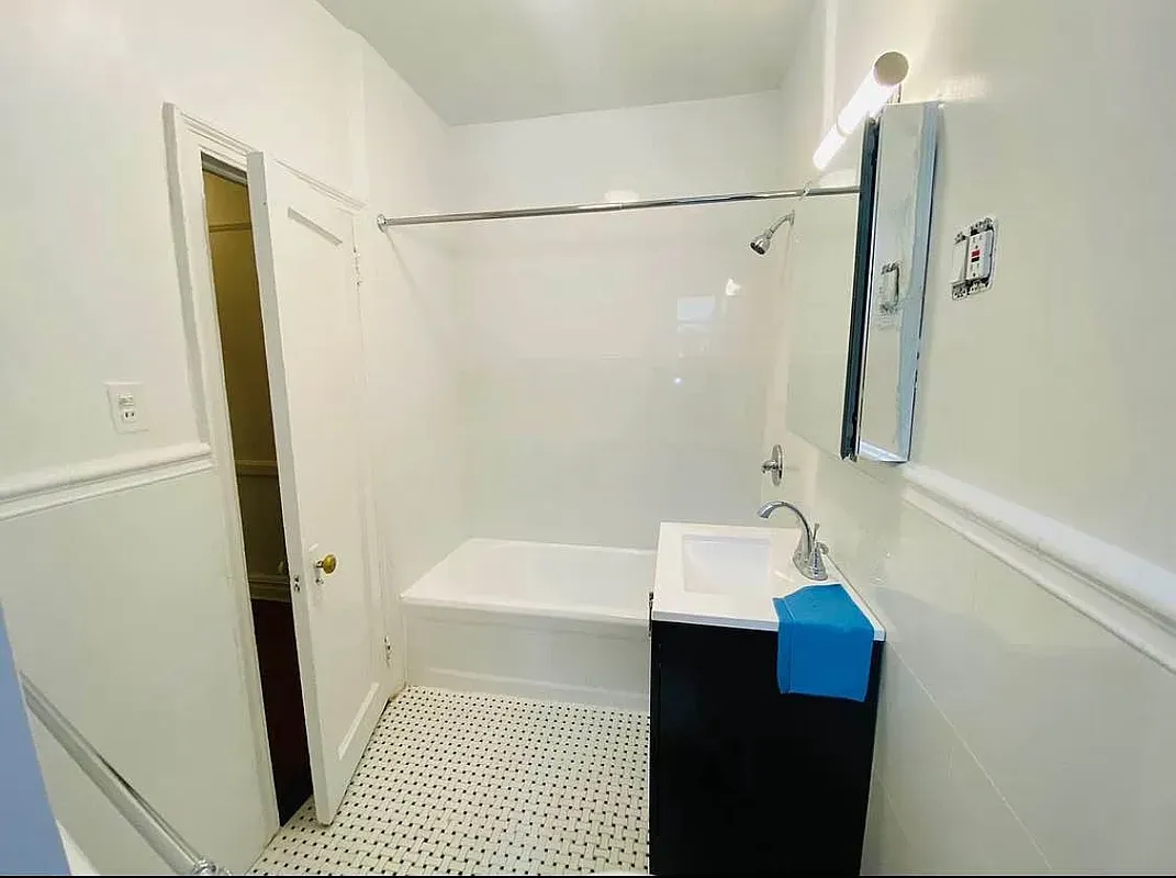a bathroom with a sink a shower and a mirror
