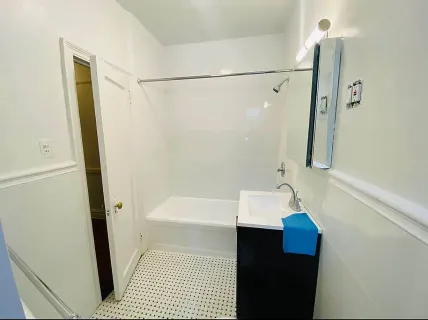 a bathroom with a sink a shower and a mirror