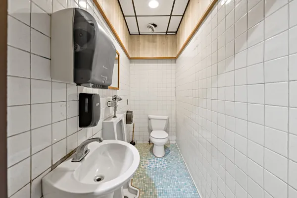 a bathroom with a sink a toilet and mirror
