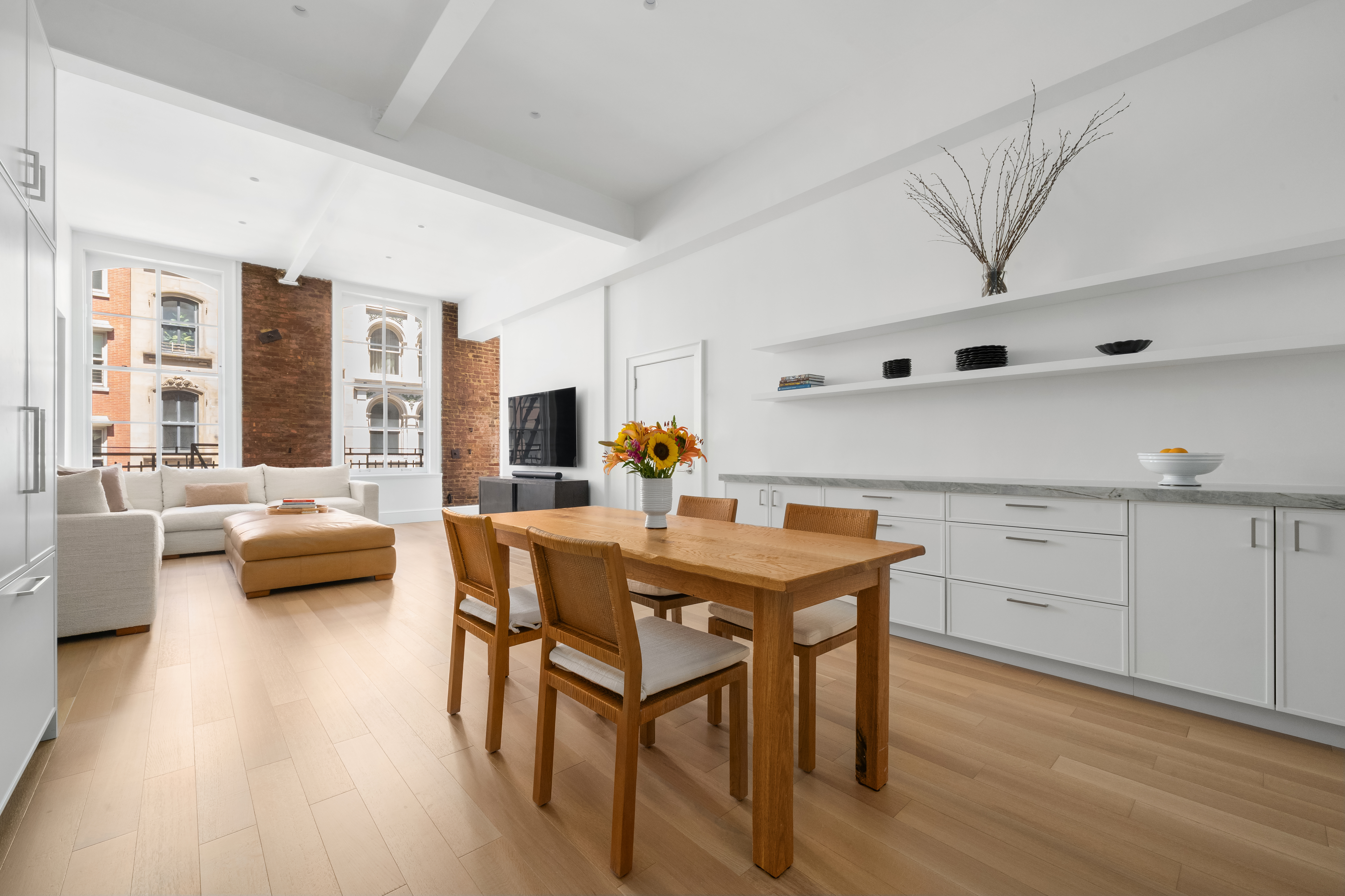 51 Warren Street, Unit 3W Manhattan, NY 10007 - Photo 7 of 13 a living room with furniture and a large window