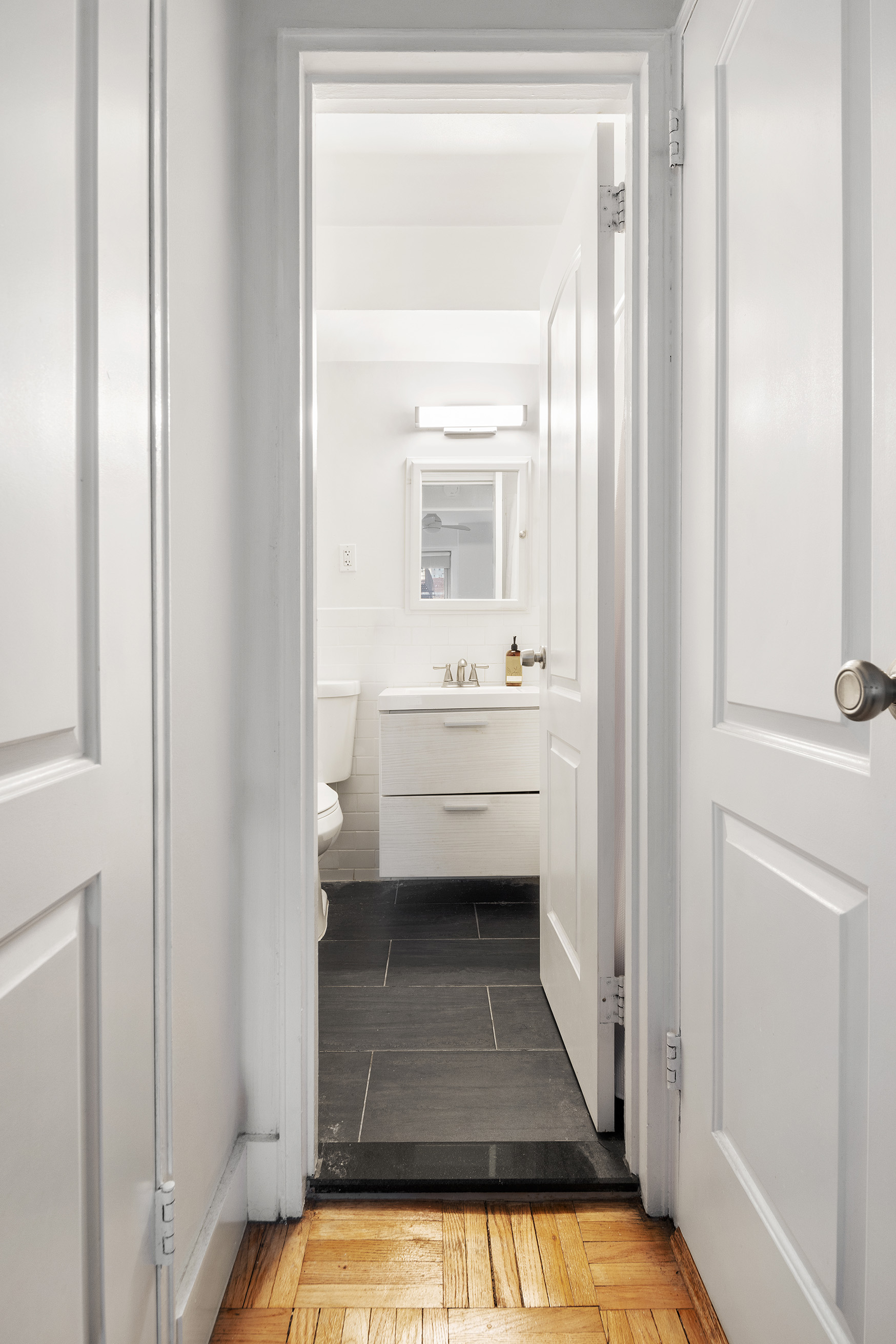 175 West 12th Street, Unit 5M Manhattan, NY 10011 - Photo 7 of 10 a bathroom with a sink and a mirror