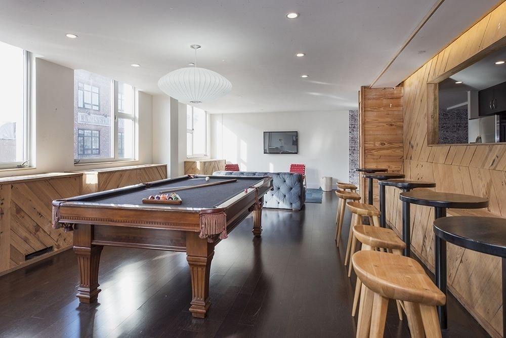 250 Bedford Avenue, Unit 129203 Brooklyn, NY 11249 - Photo 8 of 10 a room with wooden floor table and chairs