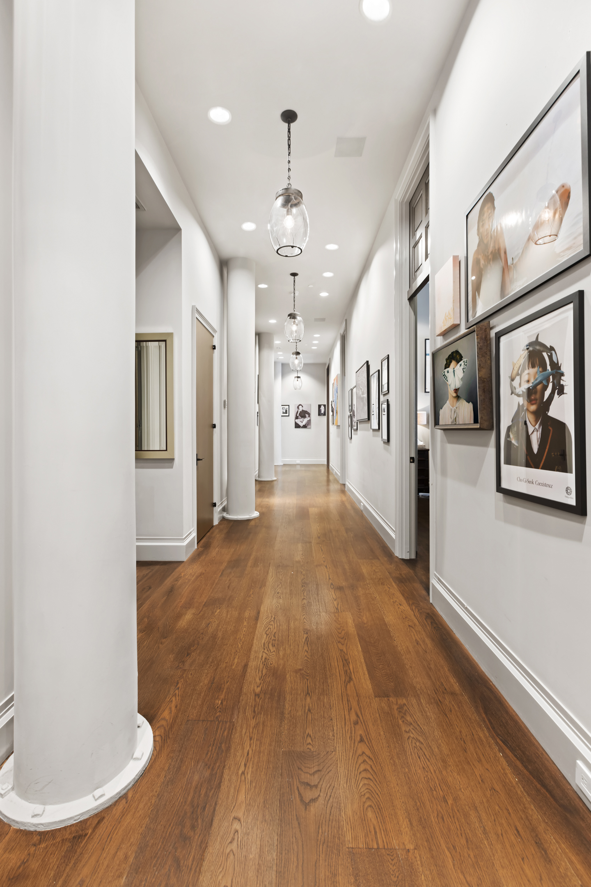114 Liberty Street, Unit 2A Manhattan, NY 10006 - Photo 7 of 17 a view of a hallway with wooden floor and chandelier