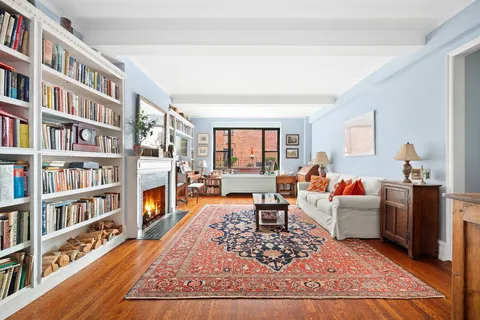 a living room with furniture and a book shelf