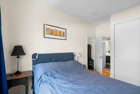a bedroom with a bed and a lamp on table