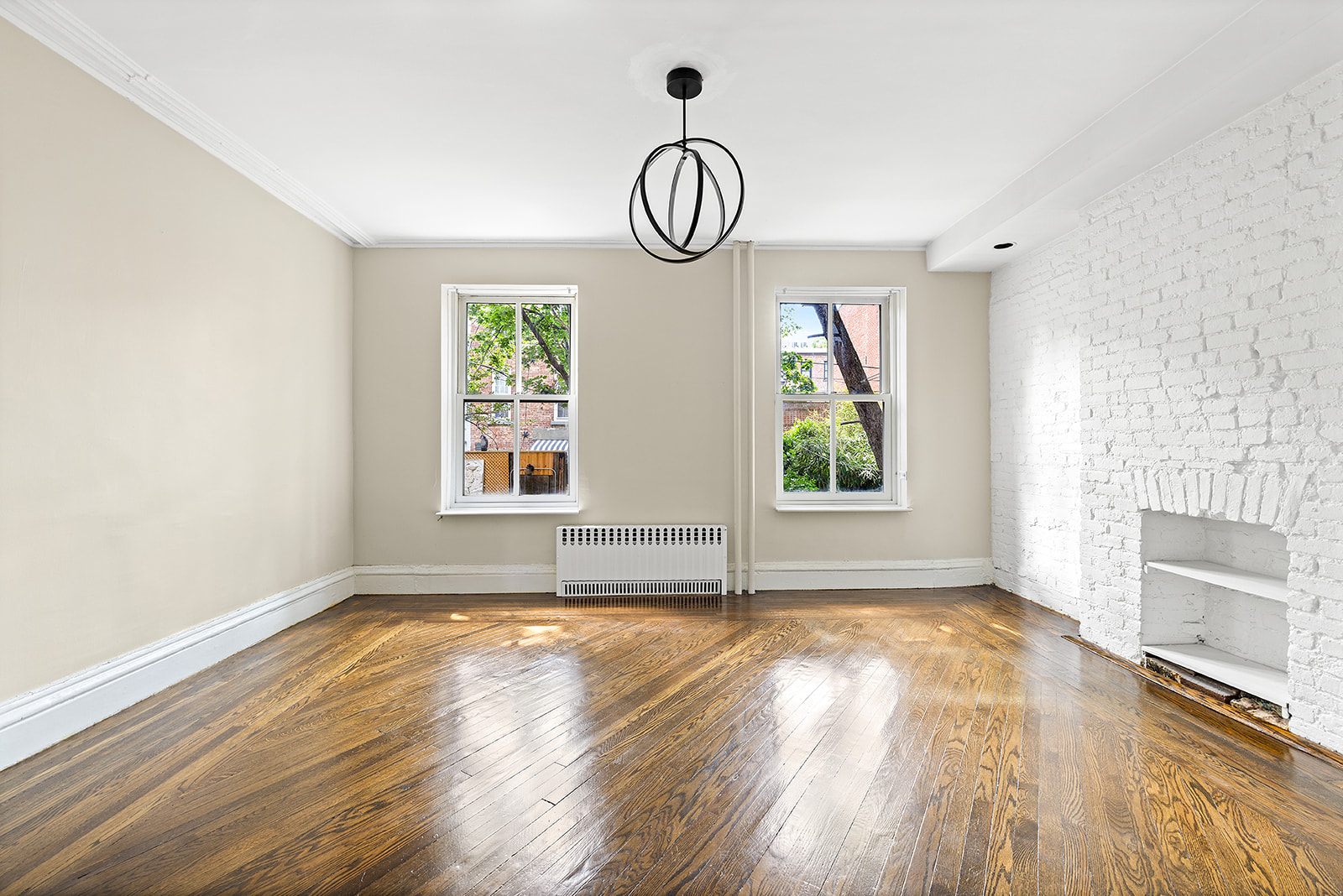 166 Congress Street, Unit A Brooklyn, NY 11201 - Photo 4 of 9 an empty space with wooden floor and windows