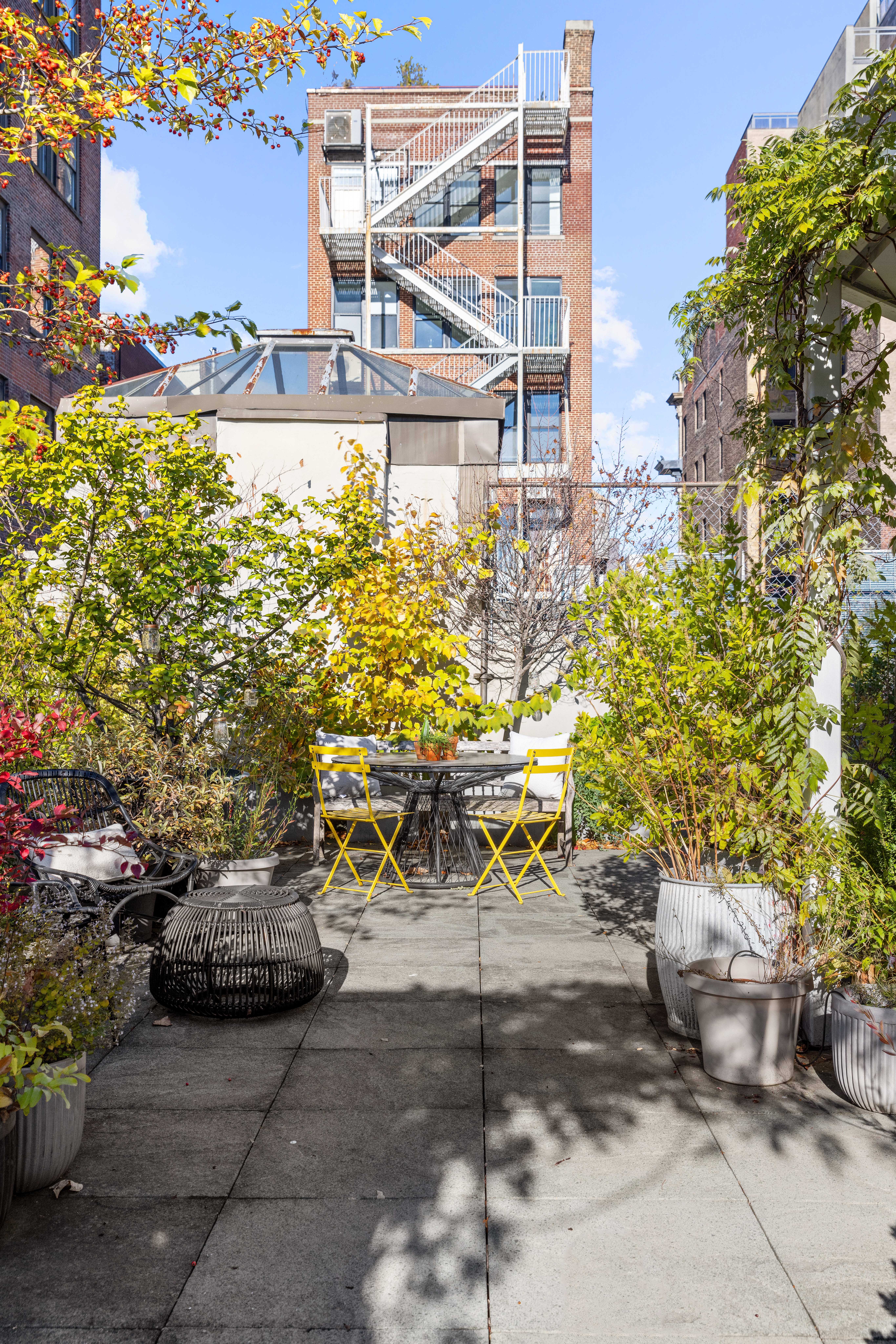 7 Bond Street, Unit PHAB Manhattan, NY 10012 - Photo 18 of 20 a view of a patio with table and chairs and potted plants