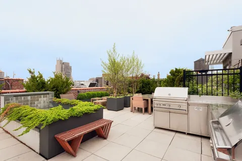 a view of a terrace with couches and a fire pit