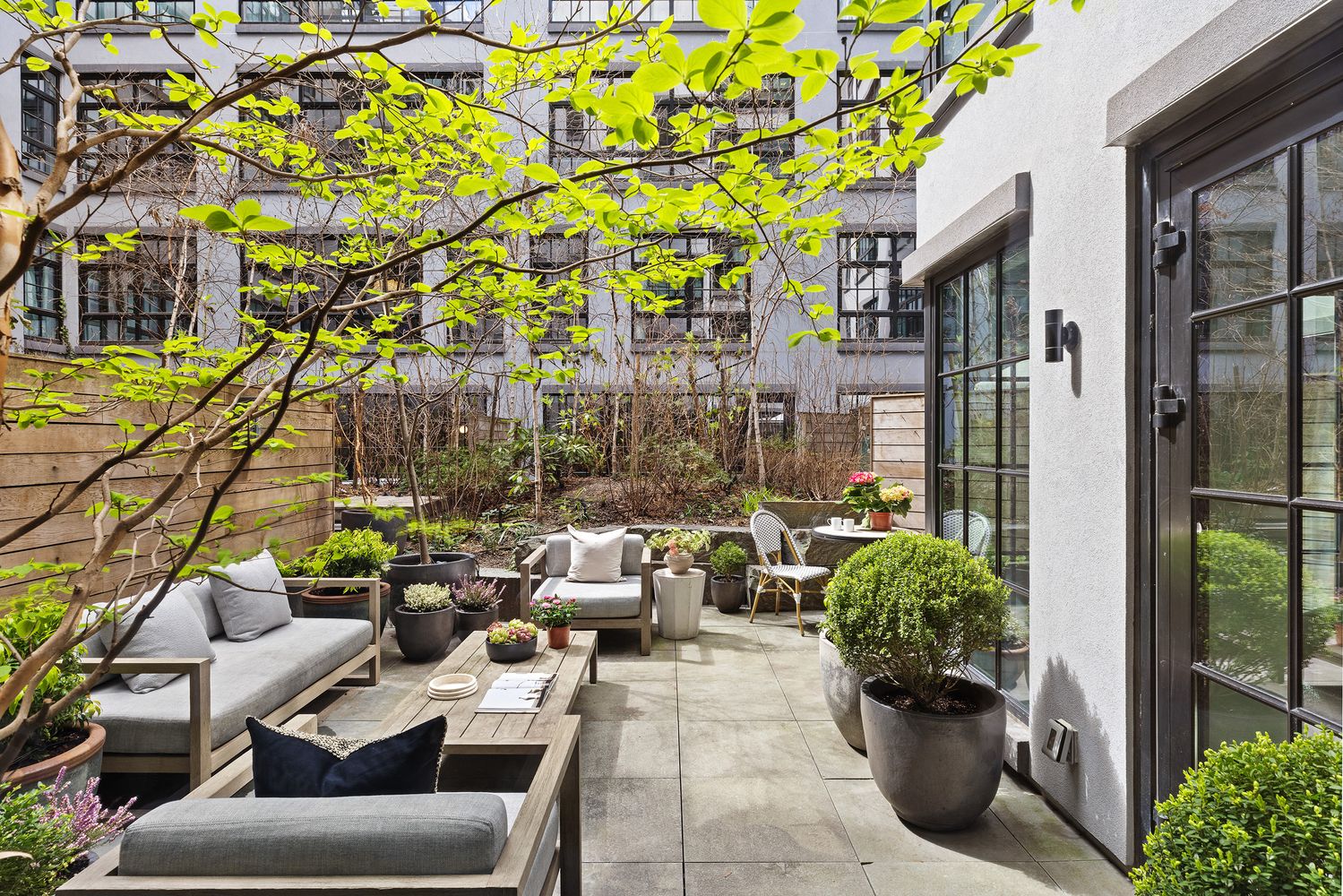 a view of a patio with couches and potted plants
