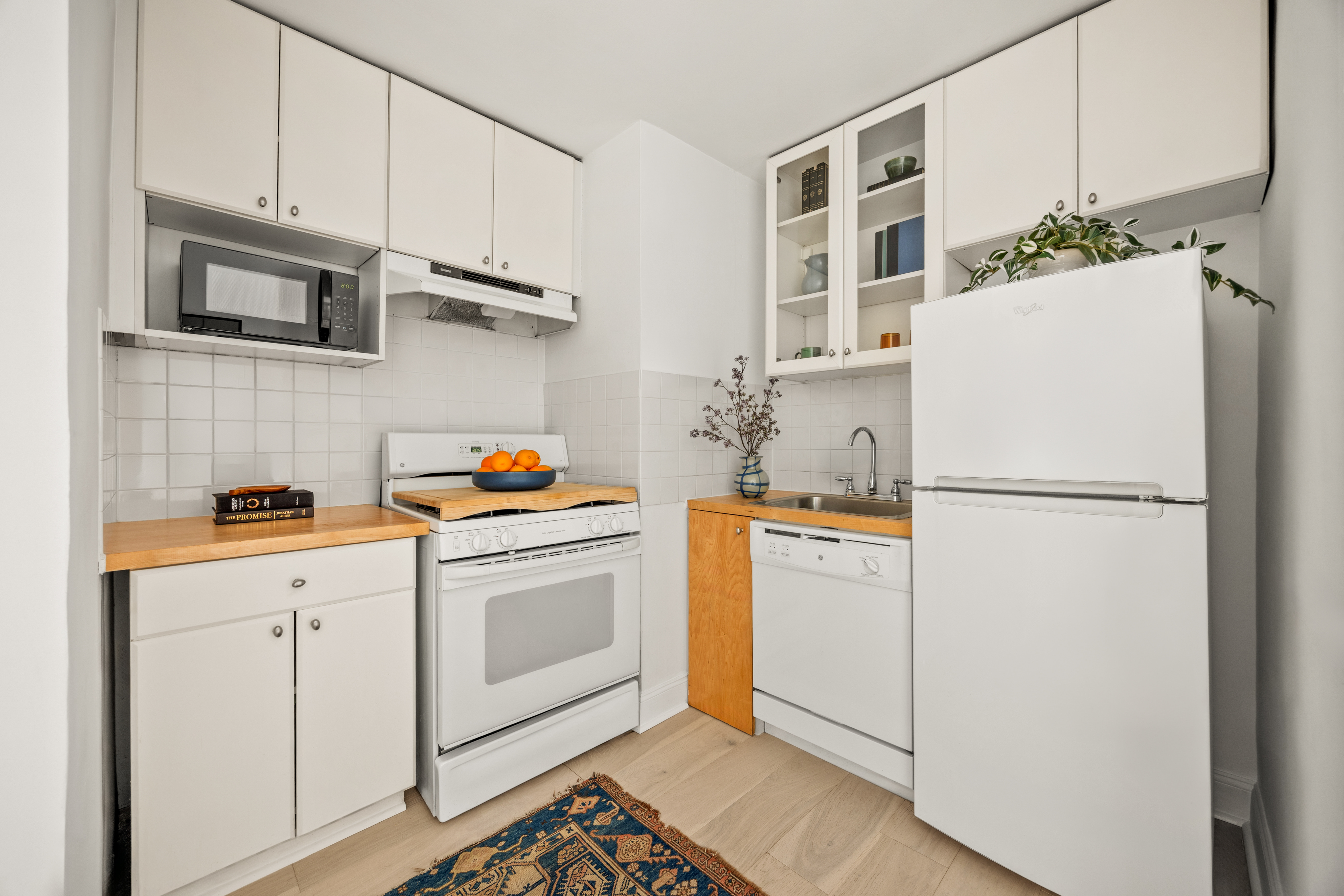 15 Charles Street, Unit 2H Manhattan, NY 10014 - Photo 7 of 12 a white refrigerator freezer sitting inside of a kitchen