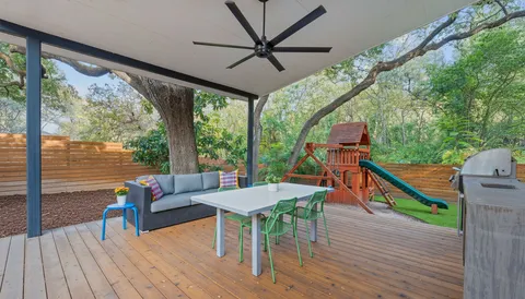 a balcony with wooden floor and outdoor seating