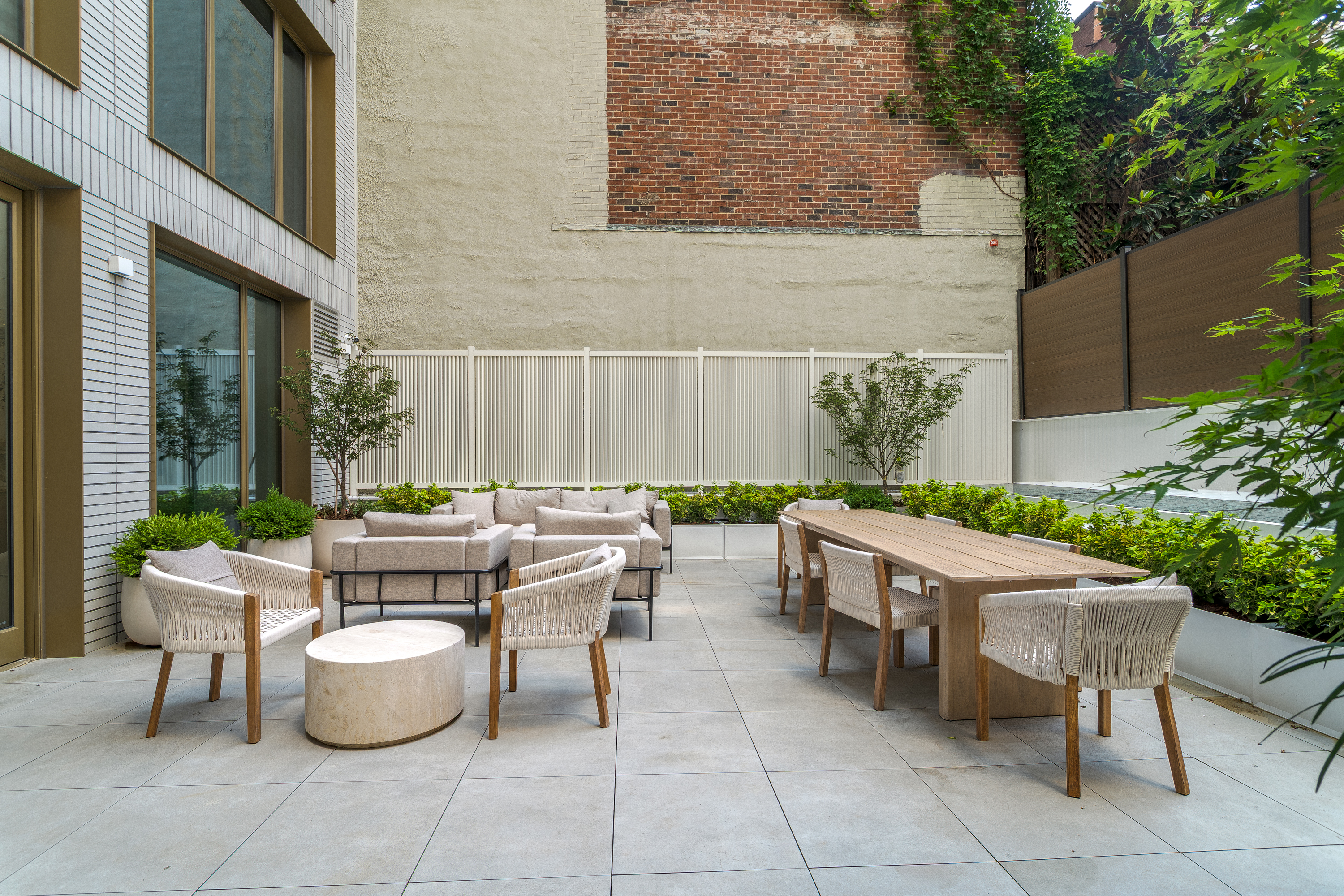 250 East 25th Street, Unit 4C Manhattan, NY 10010 - Photo 8 of 16 a backyard of a house with fountain table and chairs