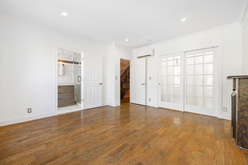 308 Clifton Place Brooklyn, NY 11216 - Photo 21 of 41 wooden floor in an empty room with a window