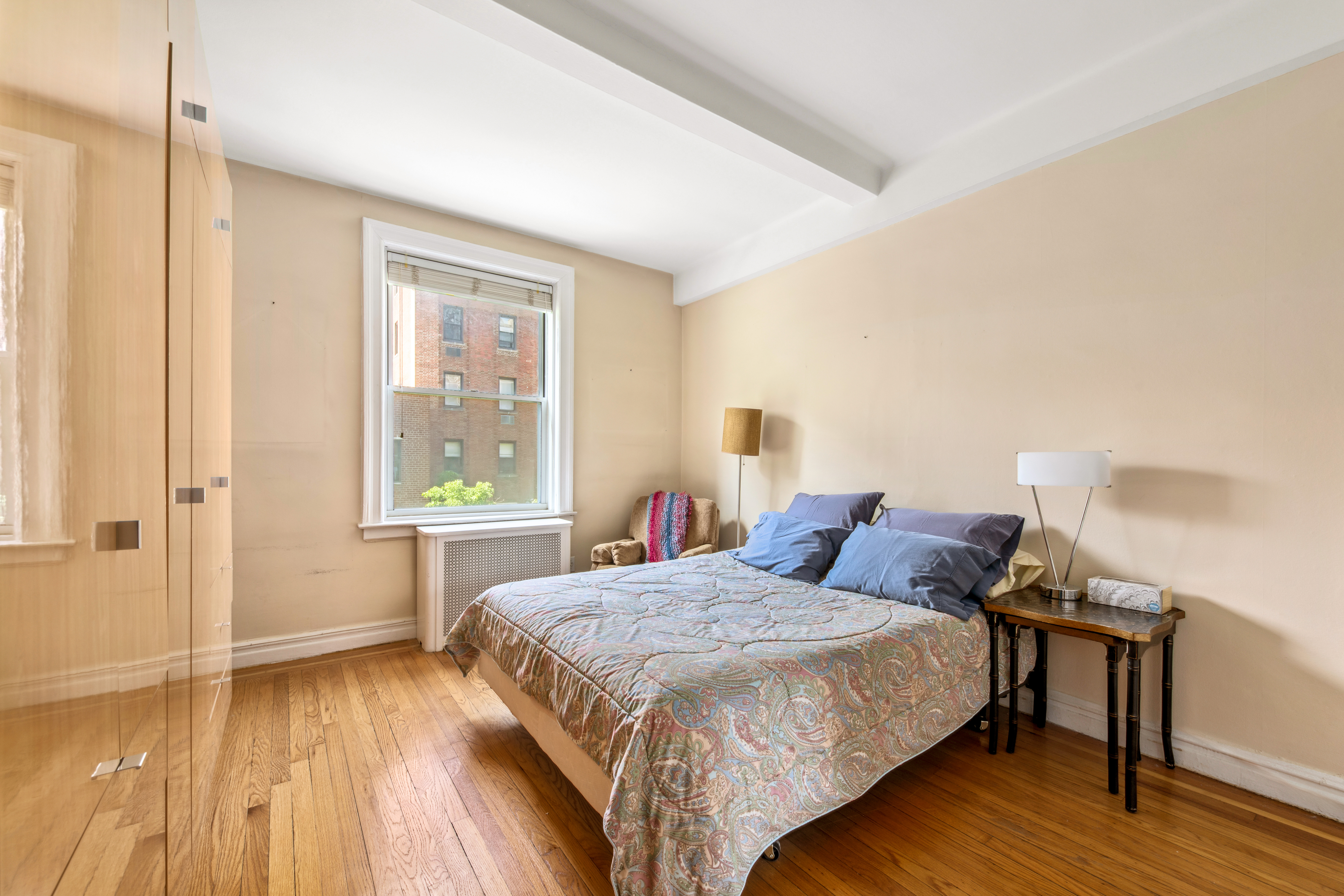 345 West 55th Street, Unit 6B Manhattan, NY 10019 - Photo 8 of 10 a bedroom with a bed and wooden floor