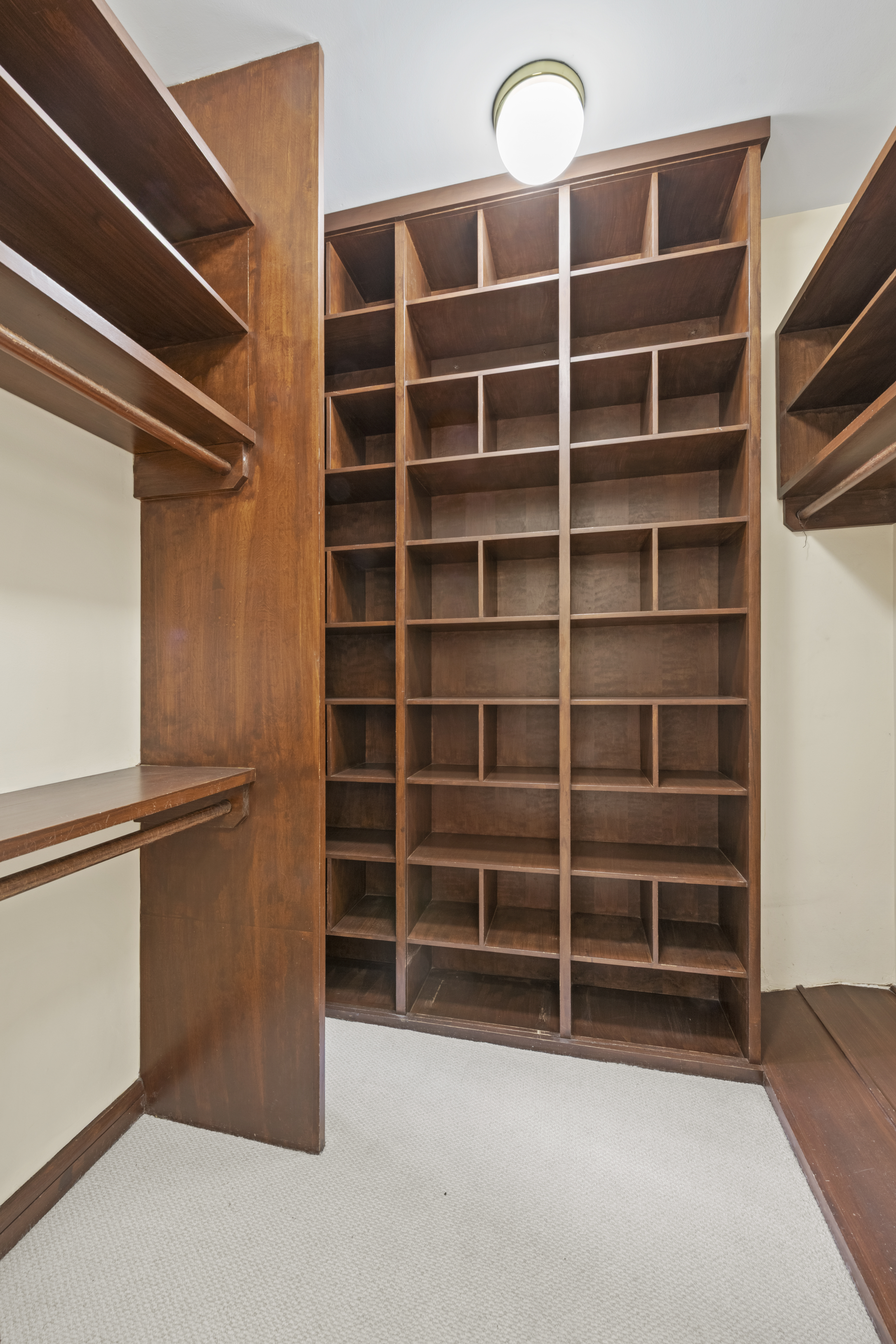 313 West 102nd Street Manhattan, NY 10025 - Photo 16 of 36 a view of an empty room with empty shelves