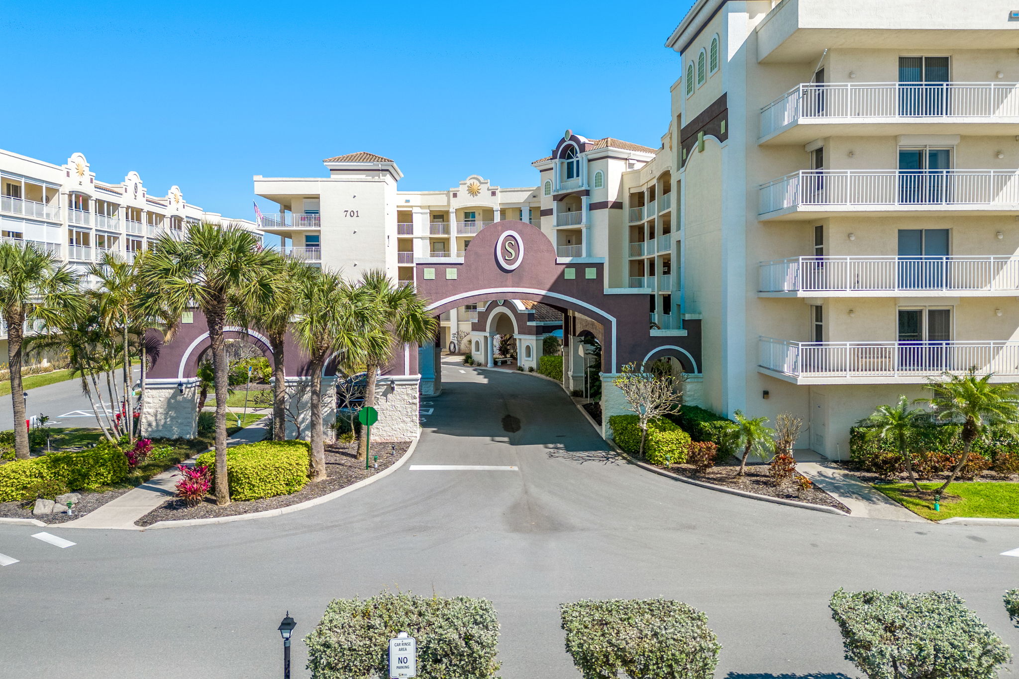 701 Solana Shores Drive, Unit 306 Cape Canaveral, FL 32920 - Photo 17 of 23 a front view of a building with garden and parking