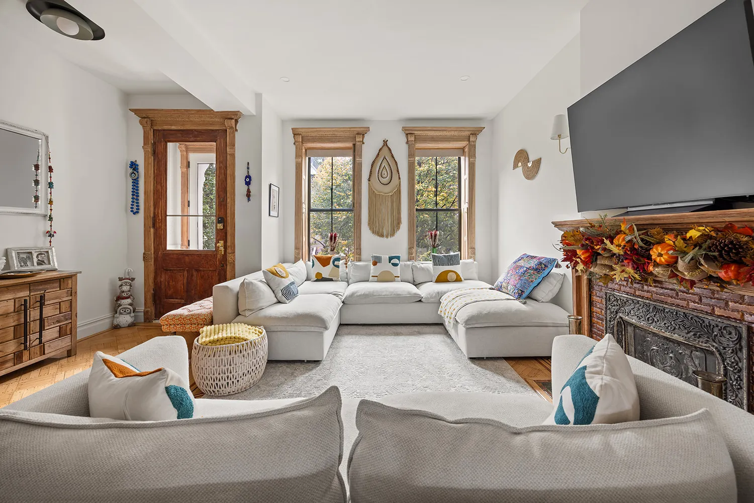 a living room with couches a coffee table and a flat screen tv