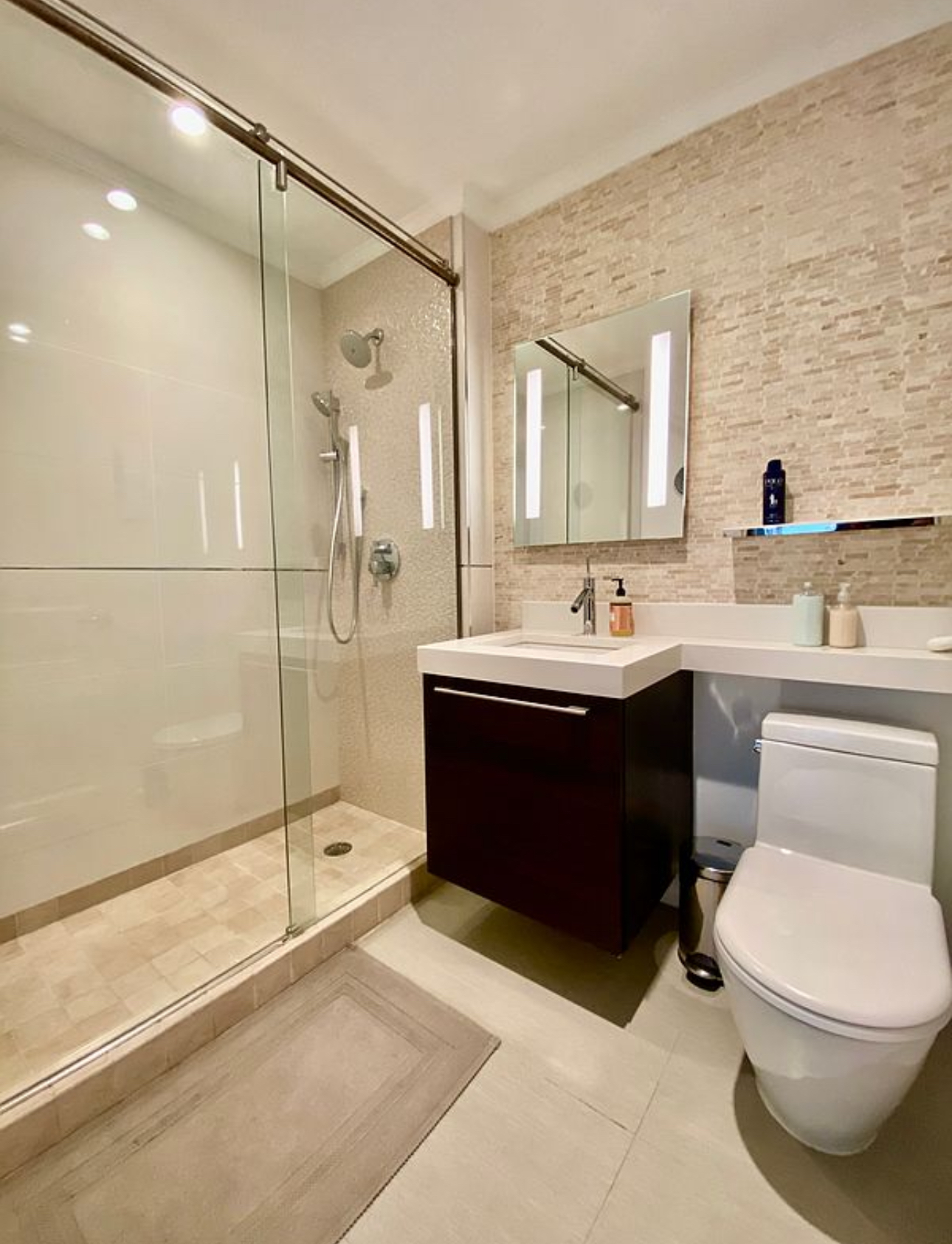 404 East 76th Street, Unit 30A Manhattan, NY 10021 - Photo 11 of 17 a bathroom with a sink a toilet and shower