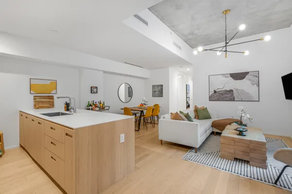 a living room with furniture and kitchen view