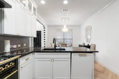 a kitchen with a sink and cabinets
