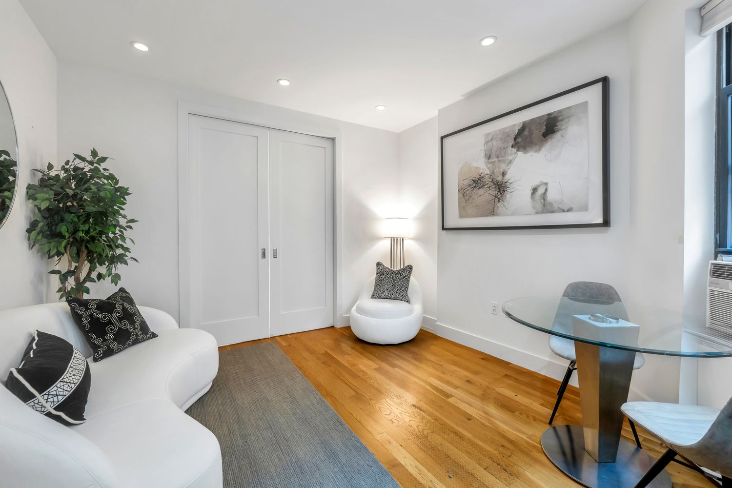 223 West 10th Street, Unit 2C Manhattan, NY 10014 - Photo 4 of 11 a living room with furniture and a potted plant