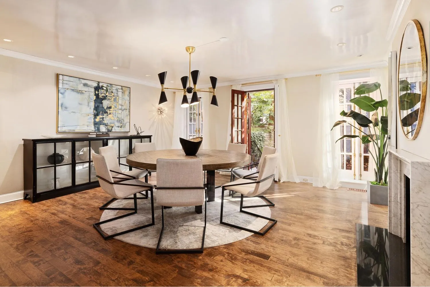 a view of a livingroom with furniture and a dining table with rug