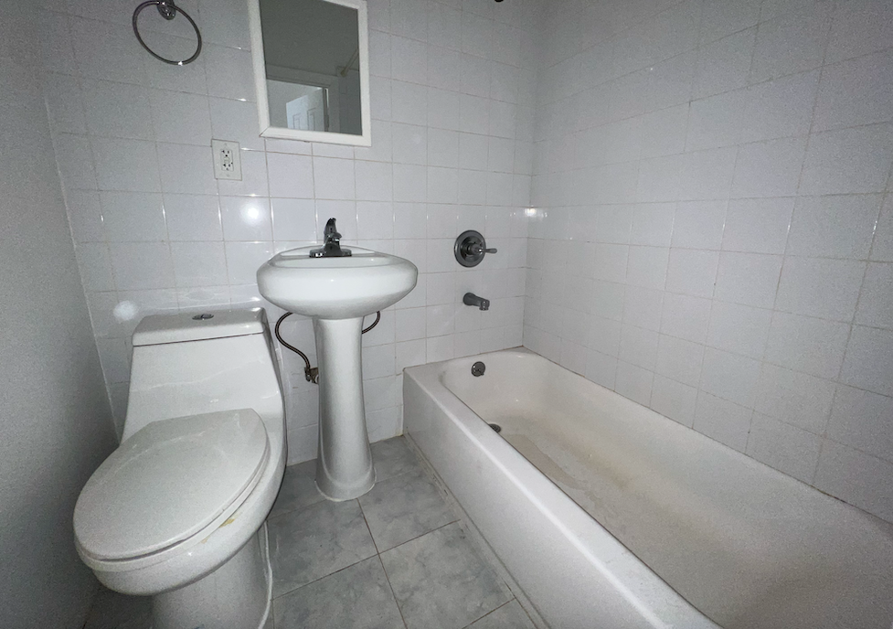 446 West 46th Street, Unit 16 Manhattan, NY 10036 - Photo 9 of 12 a bathroom with a sink a toilet and bathtub