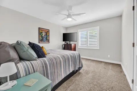 a bedroom with a bed and a tv