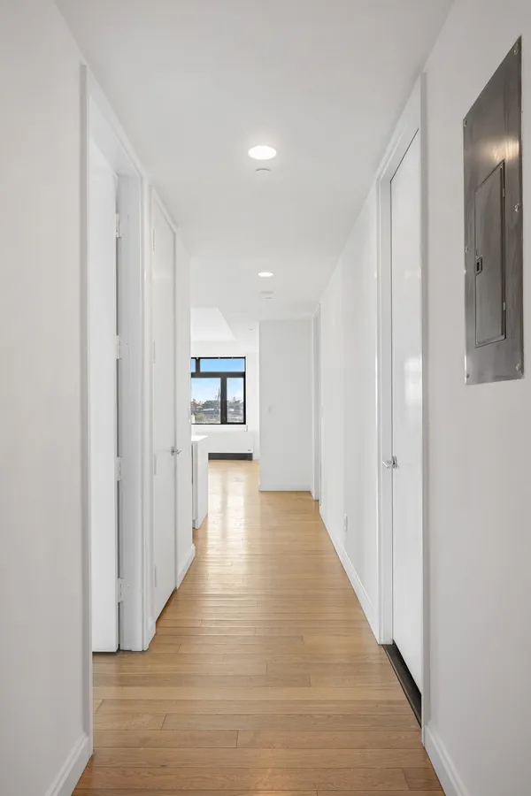 a view of a hallway with wooden floor