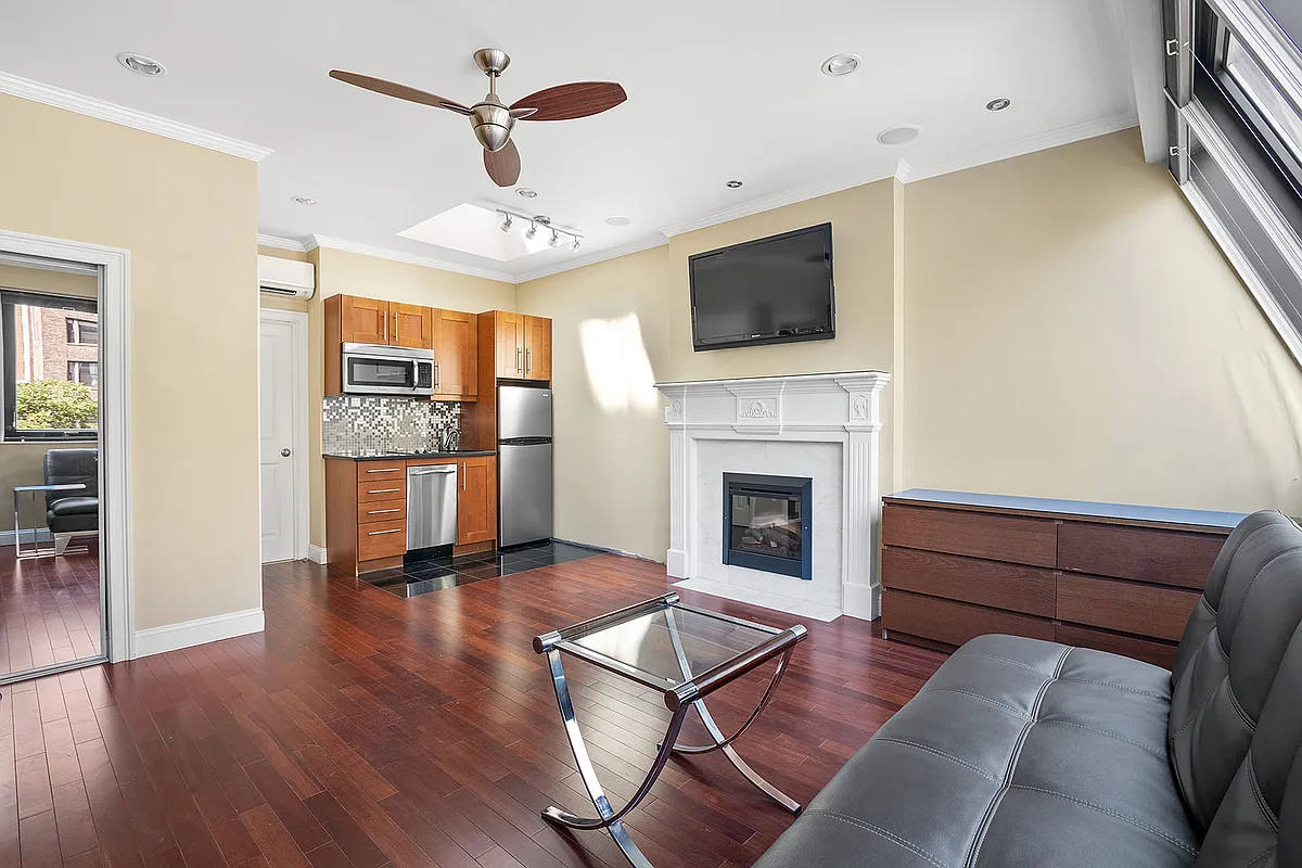 258 West 71st Street, Unit 3A Manhattan, NY 10023 - Photo 2 of 8 a living room with furniture fireplace and flat screen tv