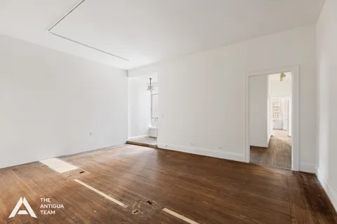 an empty room with wooden floor