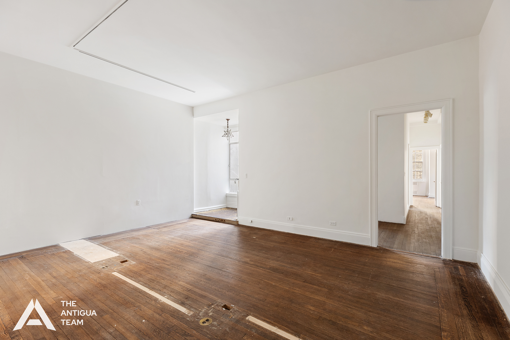 45 East 66th Street, Unit 4N Manhattan, NY 10065 - Photo 3 of 10 an empty room with wooden floor
