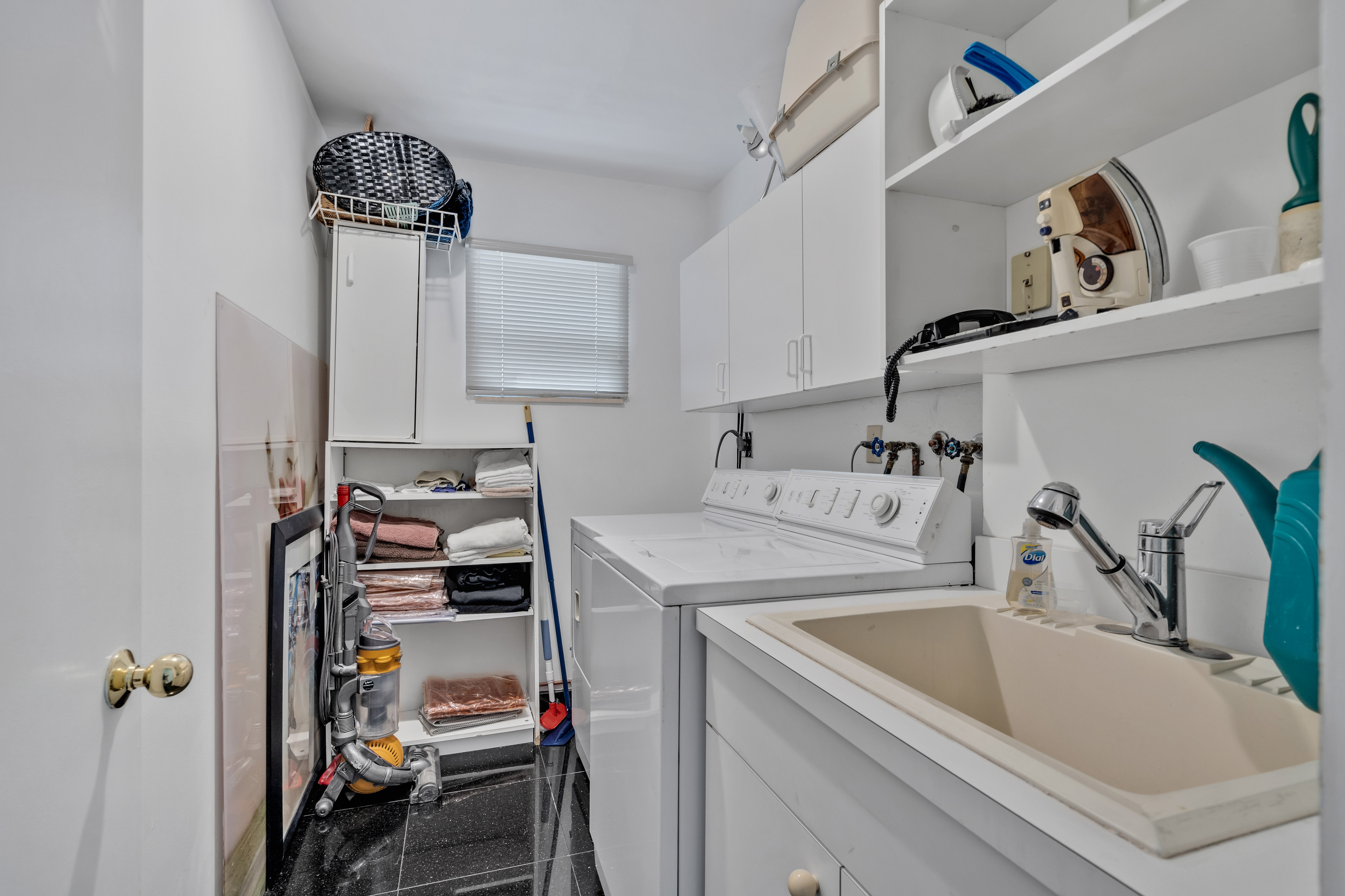 8768 Southwest 62nd Court Miami, FL 33156 - Photo 28 of 56 a kitchen with a sink and cabinets