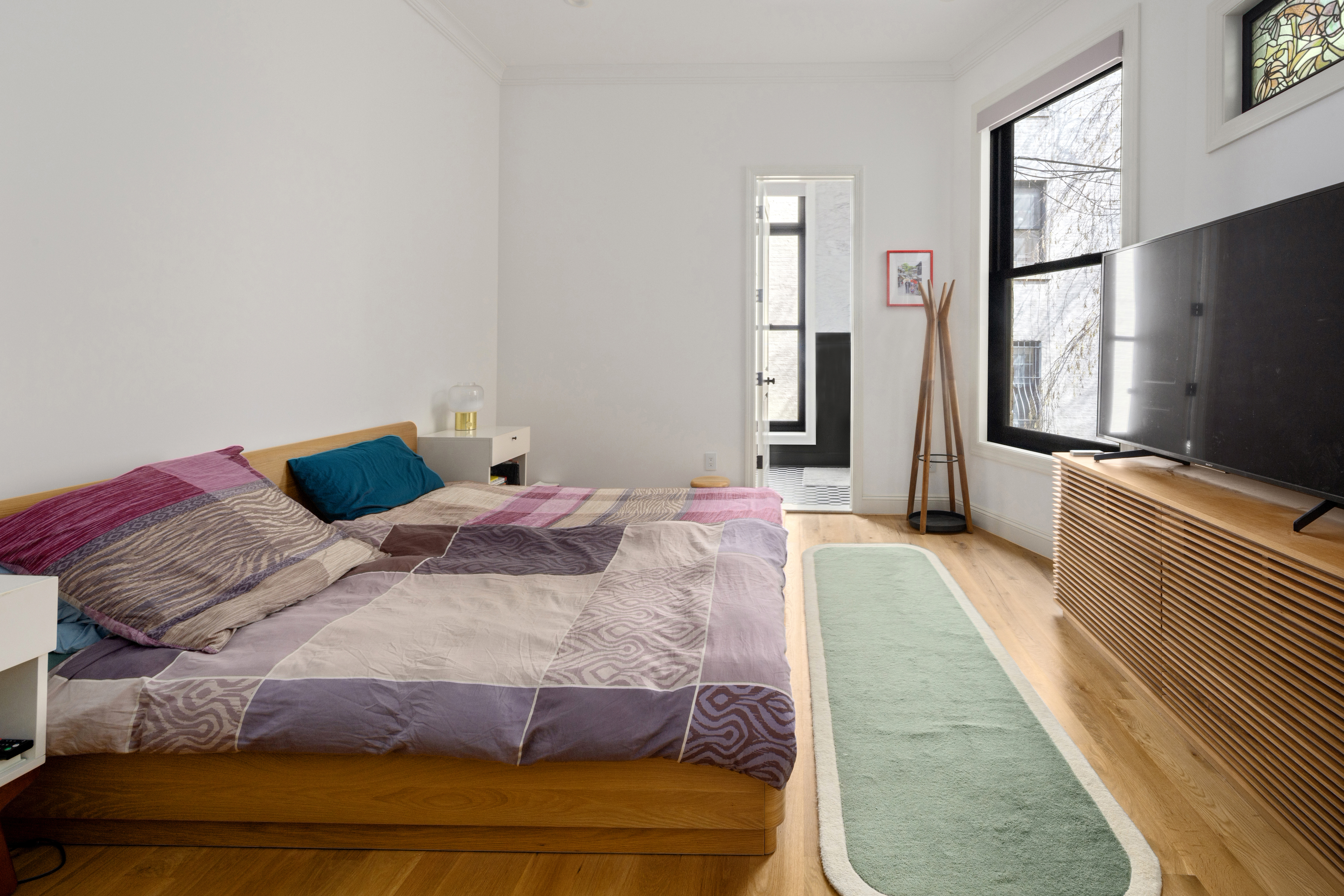 75 8th Avenue, Unit 2 Brooklyn, NY 11215 - Photo 7 of 16 a bedroom with a bed and flat tv screen