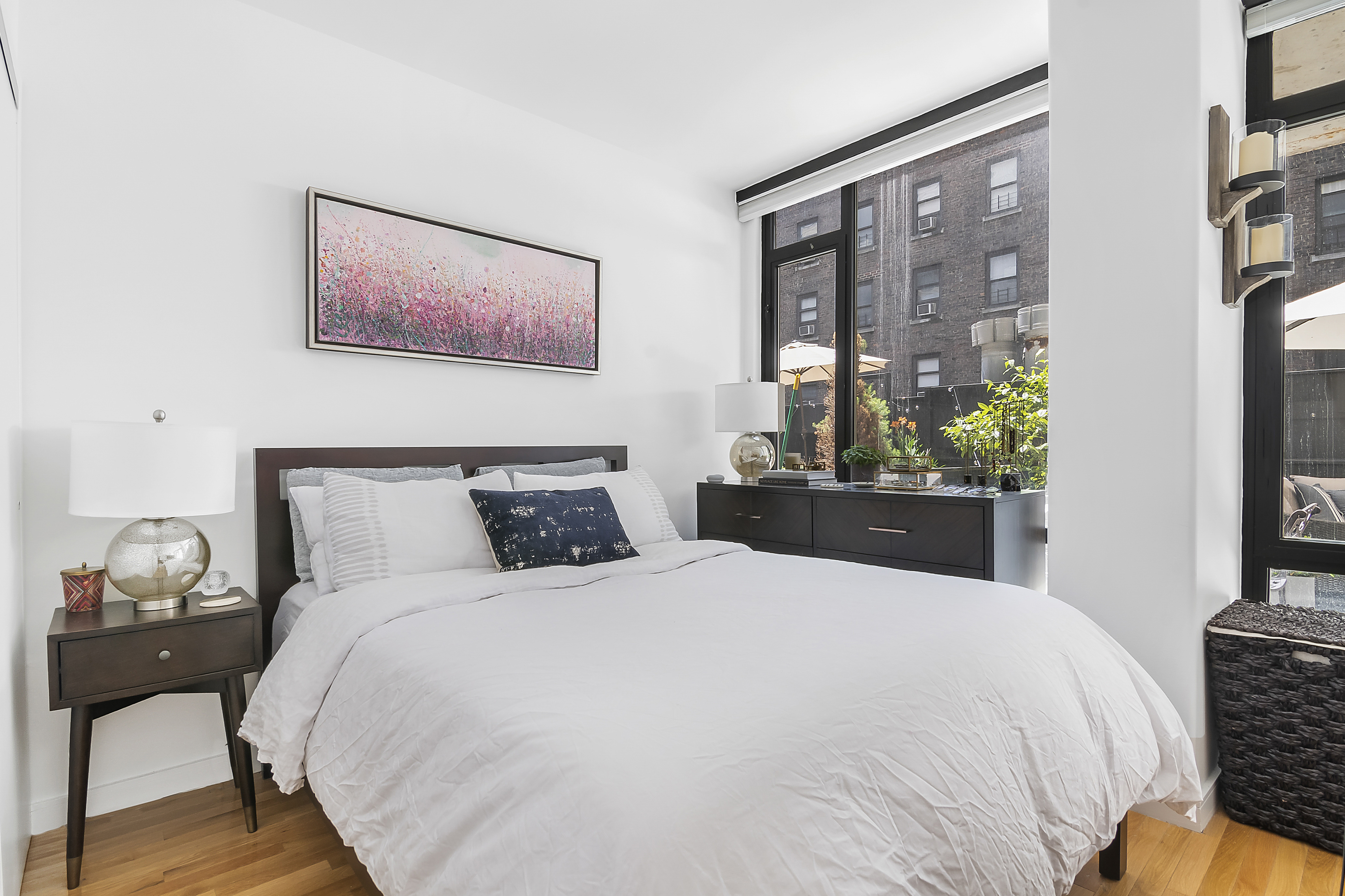 148 East 24th Street, Unit 3F Manhattan, NY 10010 - Photo 6 of 9 a bed sitting in a bedroom next to a window