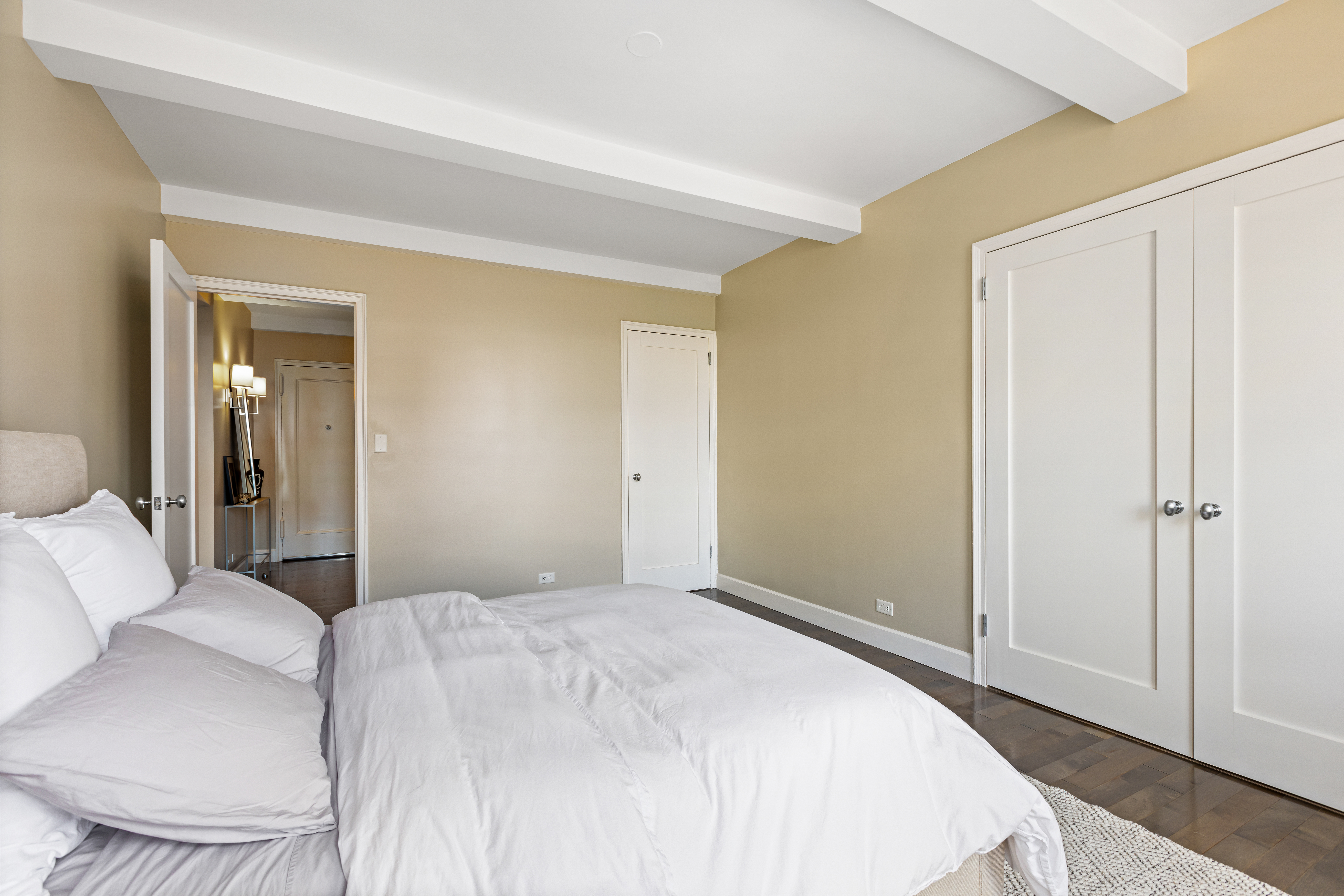 465 West 23rd Street, Unit 15B Manhattan, NY 10011 - Photo 9 of 19 a bedroom with a bed and a mirror